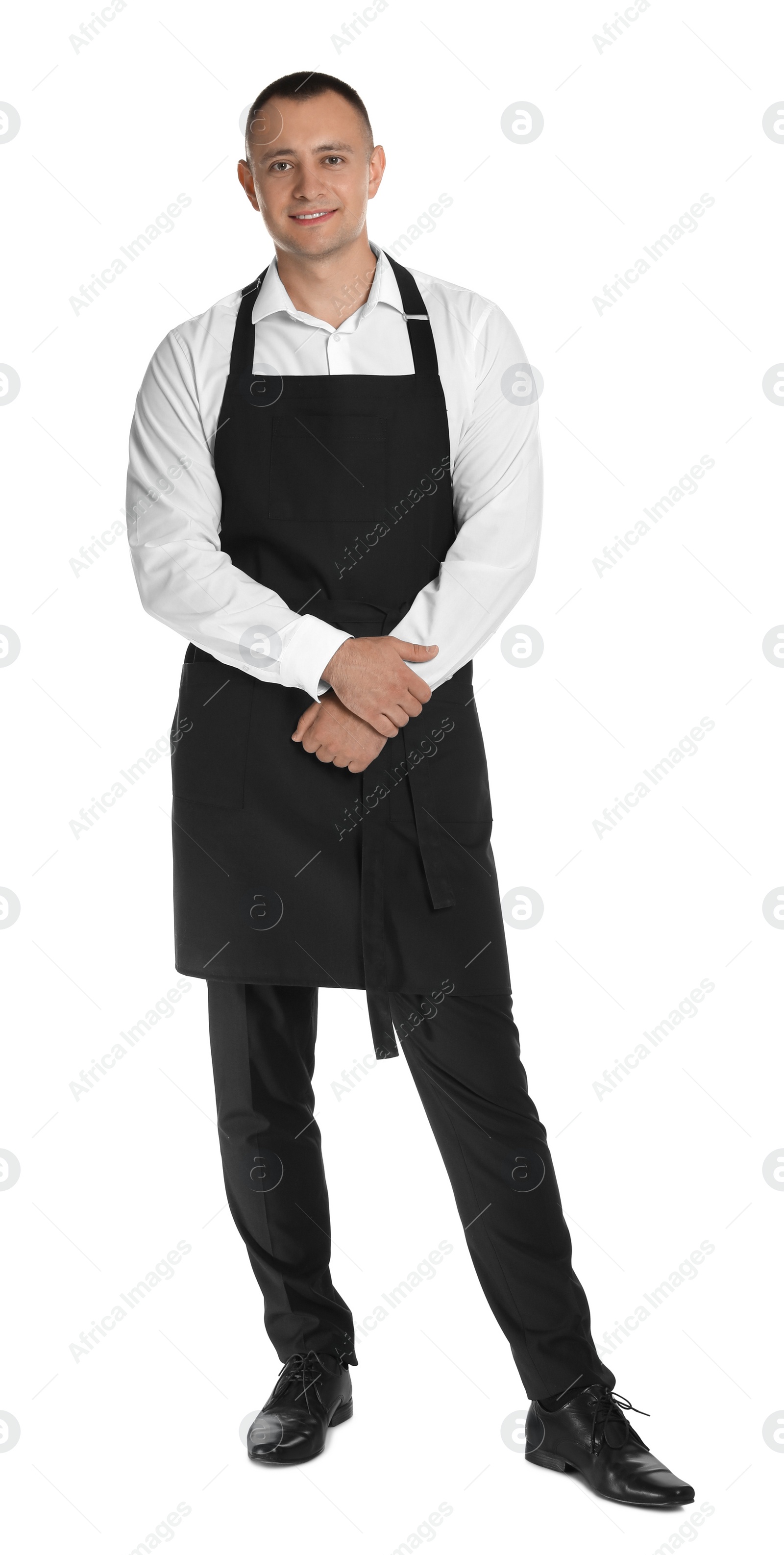 Photo of Full length portrait of happy young waiter in uniform on white background
