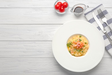 Plate with tasty shrimps and grits on table, top view