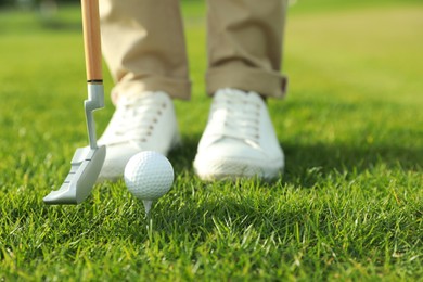Photo of Person playing golf on green course, closeup