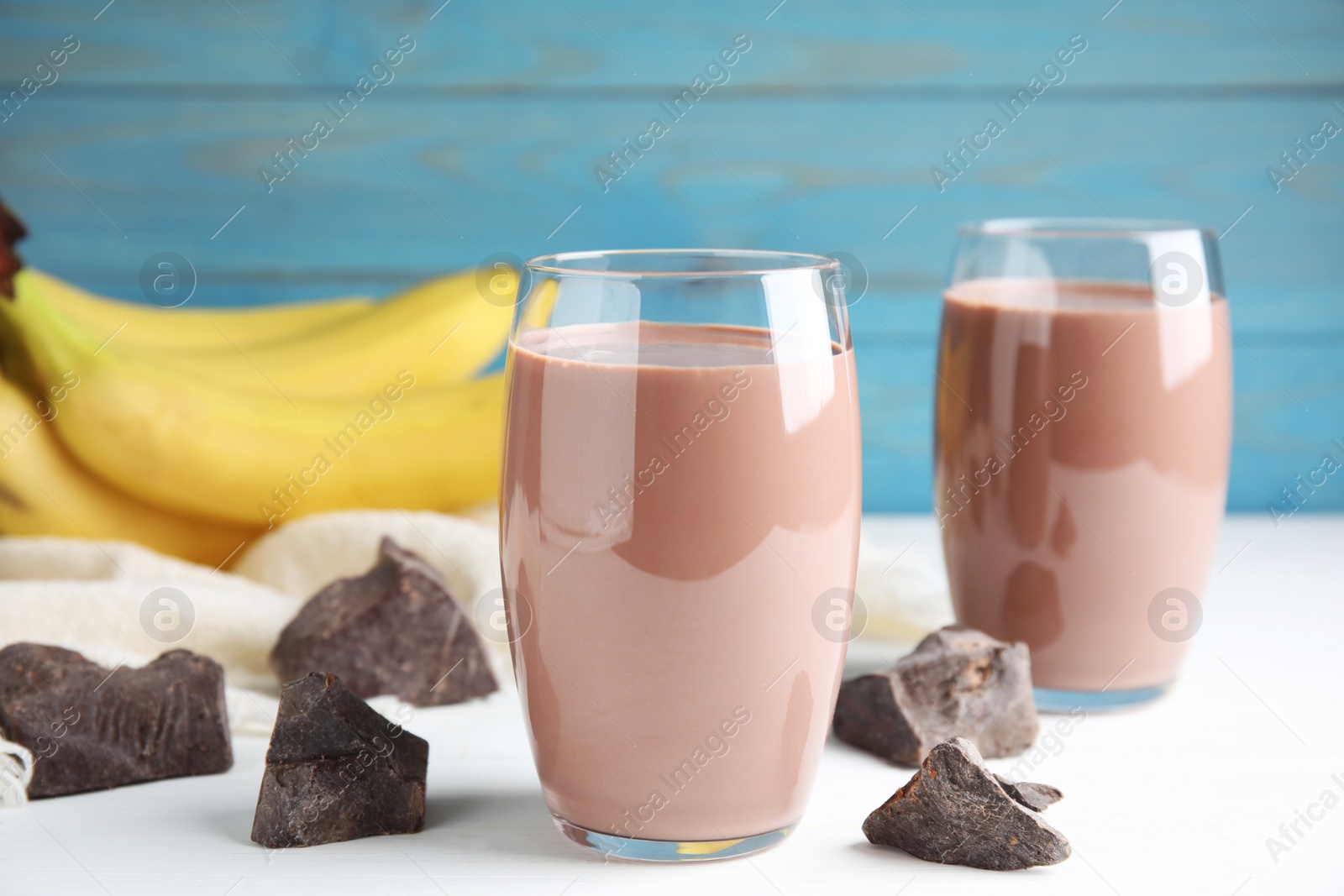 Photo of Fresh yummy chocolate milk on white table