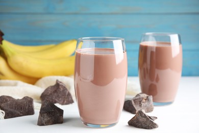 Fresh yummy chocolate milk on white table