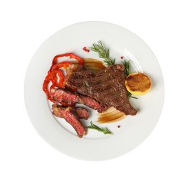 Photo of Delicious grilled beef steak with pepper, spices and lemon isolated on white, top view