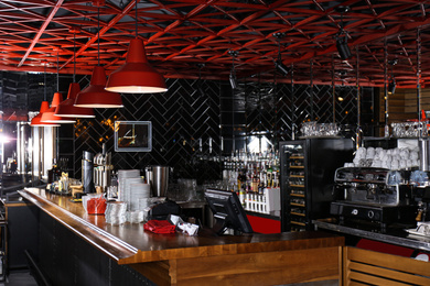 Photo of Stylish interior of cafe with wooden counter