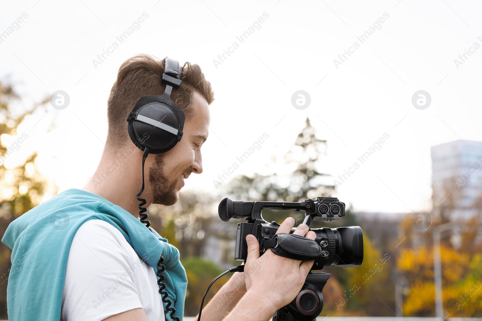 Photo of Video operator with professional camera working outdoors