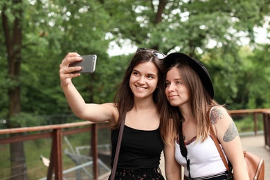 Young women taking selfie in beautiful park