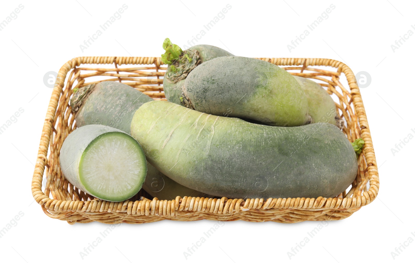 Photo of Green daikon radishes in wicker basket isolated on white