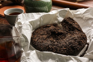 Photo of Broken disc shaped pu-erh tea on parchment paper