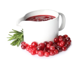 Photo of Pitcher of cranberry sauce with rosemary on white background
