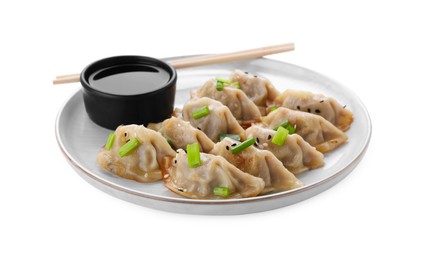 Photo of Delicious gyoza (asian dumplings) with green onions, soy sauce and chopsticks isolated on white