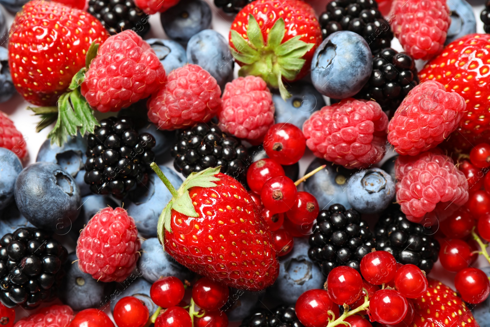 Photo of Mix of fresh delicious berries as background, top view