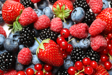 Photo of Mix of fresh delicious berries as background, top view