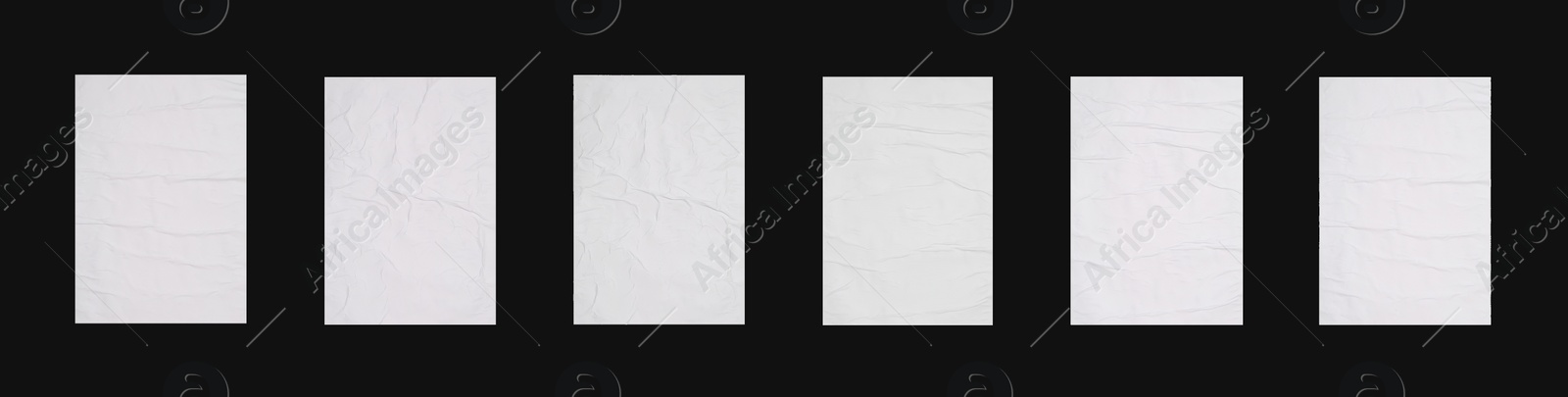 Image of Collection of creased blank posters on black background. Banner design