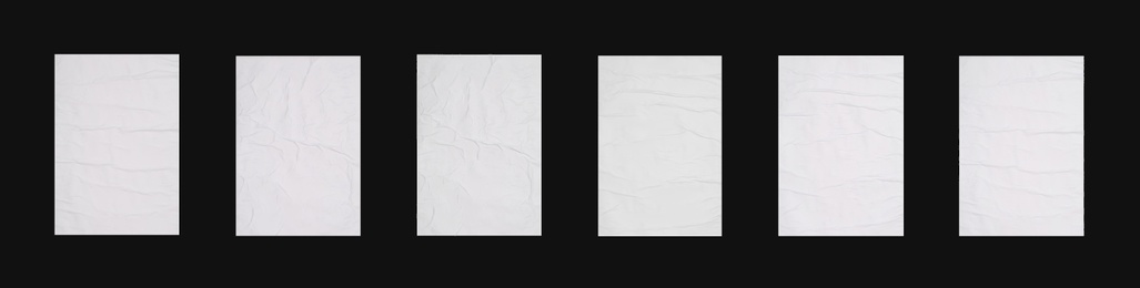 Image of Collection of creased blank posters on black background. Banner design