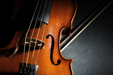 Classic violin and bow on stone table, closeup