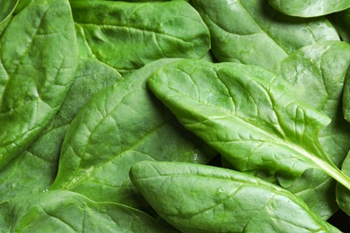 Photo of Fresh green healthy spinach as background, closeup view