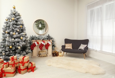 Stylish Christmas interior with decorated fir tree and fireplace