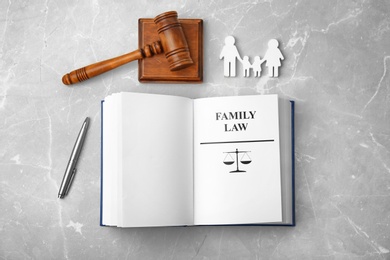 Flat lay composition with book and gavel on light background. Family law concept