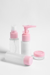 Cosmetic travel kit with personal care products on white background