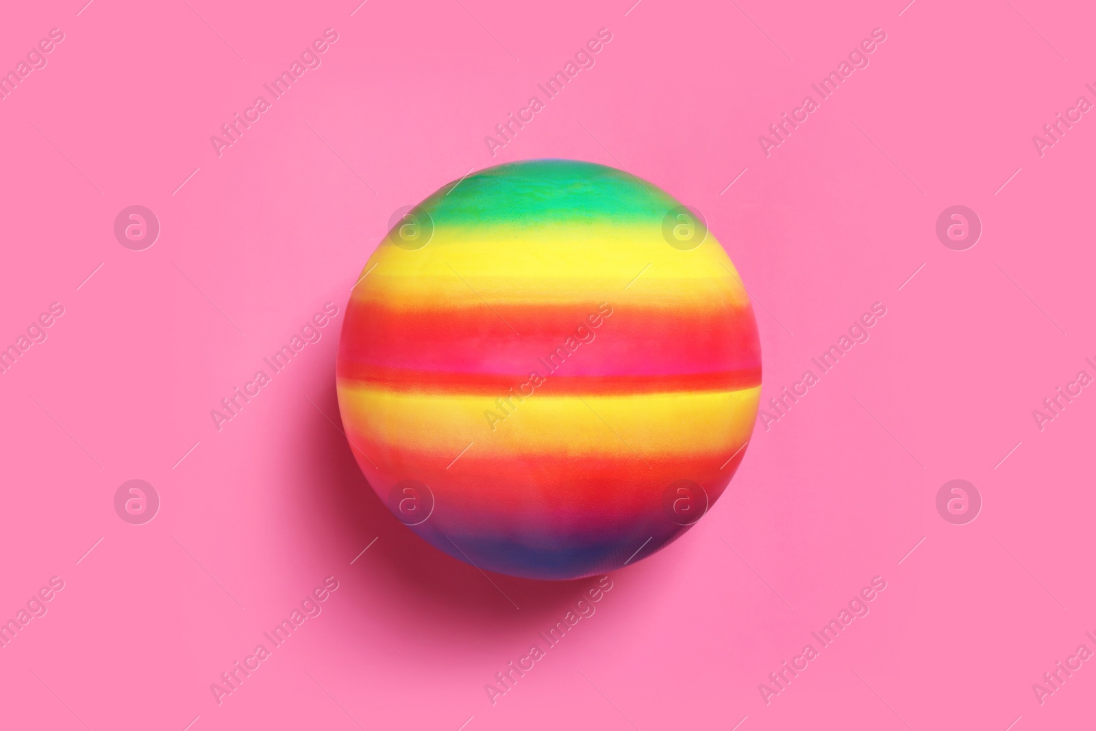 Photo of New bright kids' ball on pink background, top view