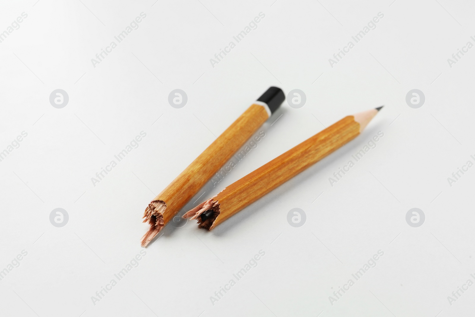 Photo of One broken graphite pencil on white background, closeup