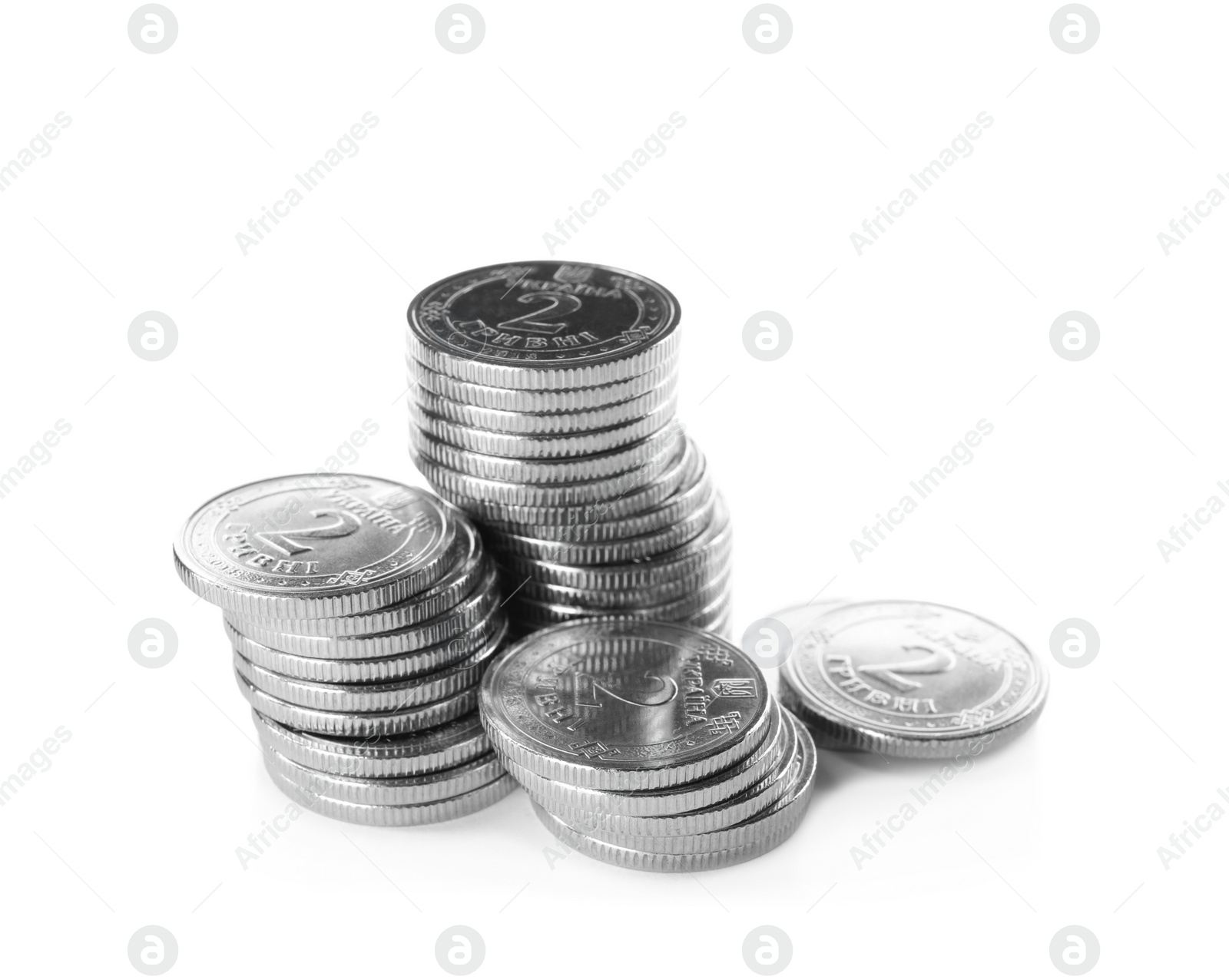 Photo of Stacks of Ukrainian coins on white background. National currency