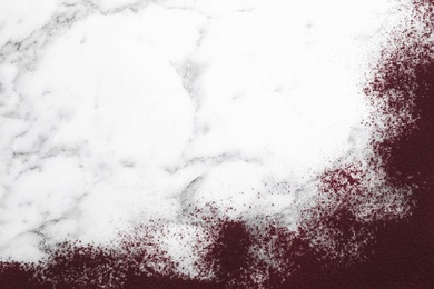 Acai powder on marble table, top view