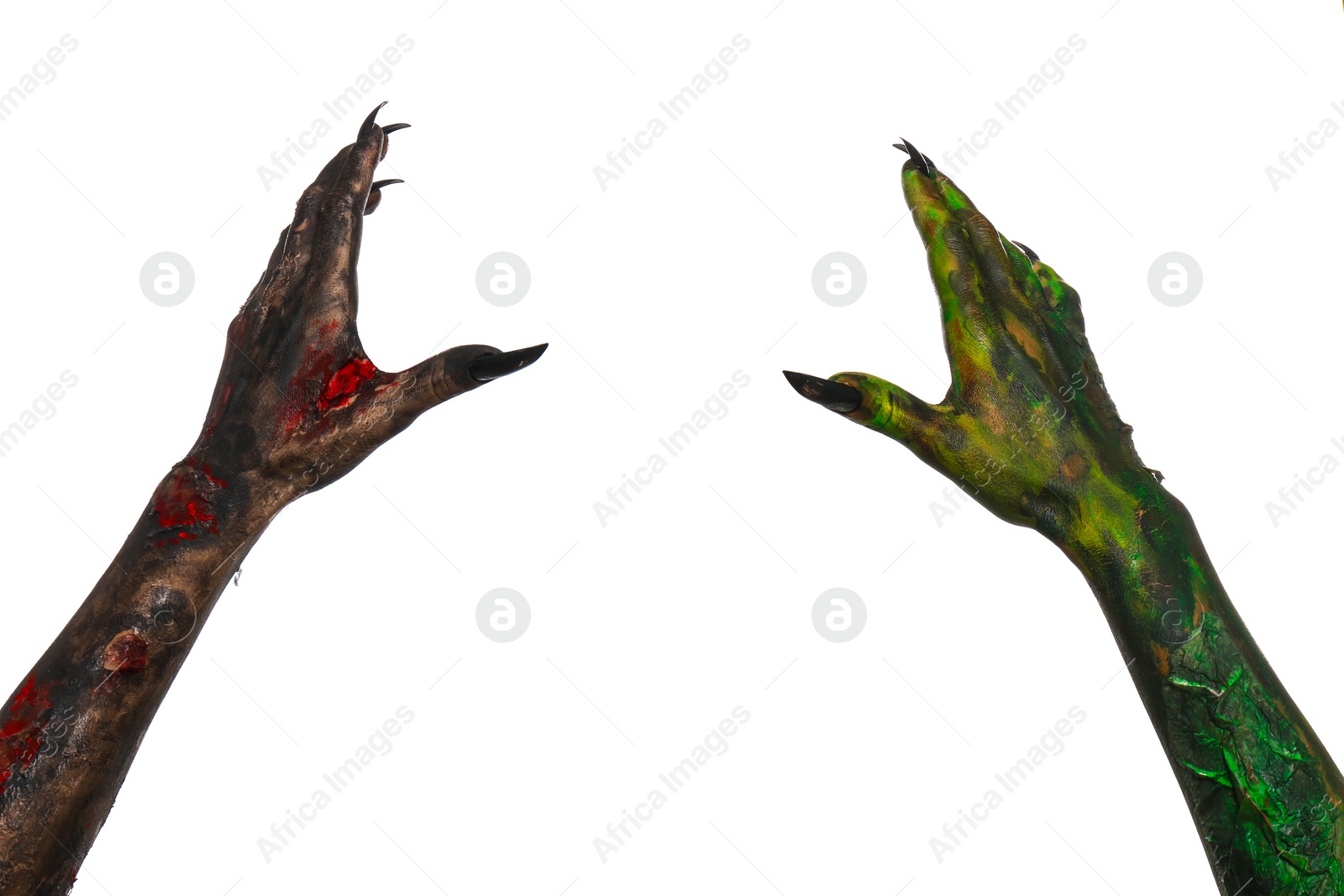 Photo of Scary monsters on white background, closeup of hands. Halloween characters