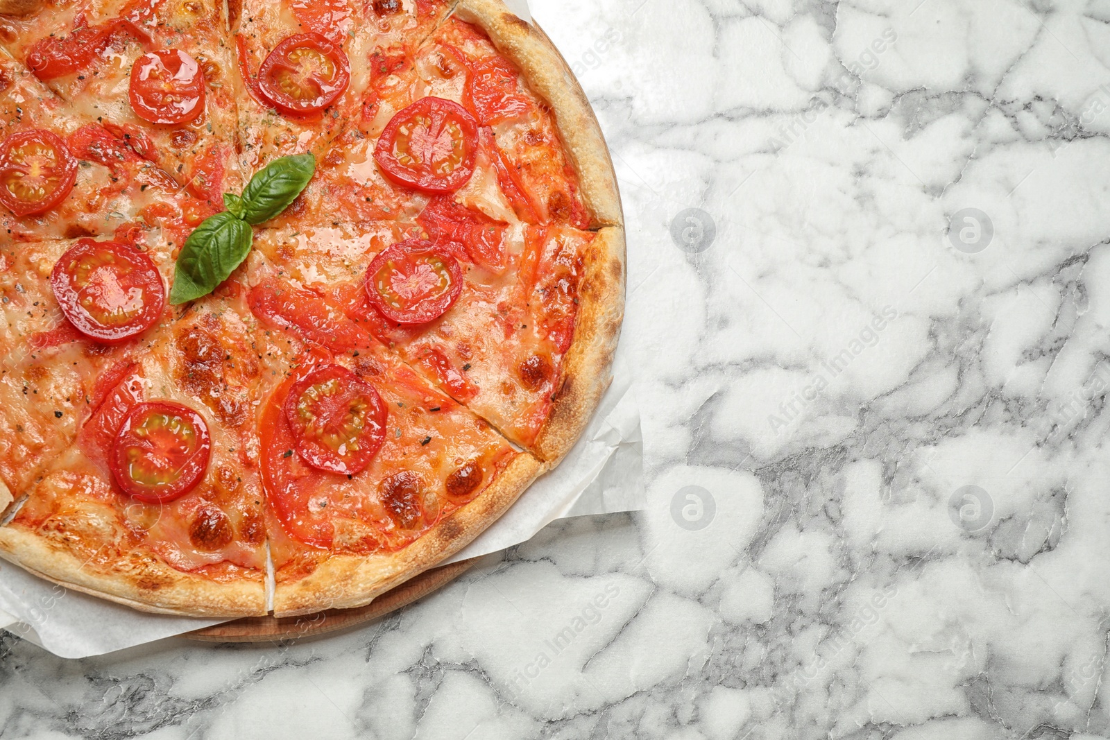 Photo of Delicious pizza Margherita on white marble table, top view. Space for text