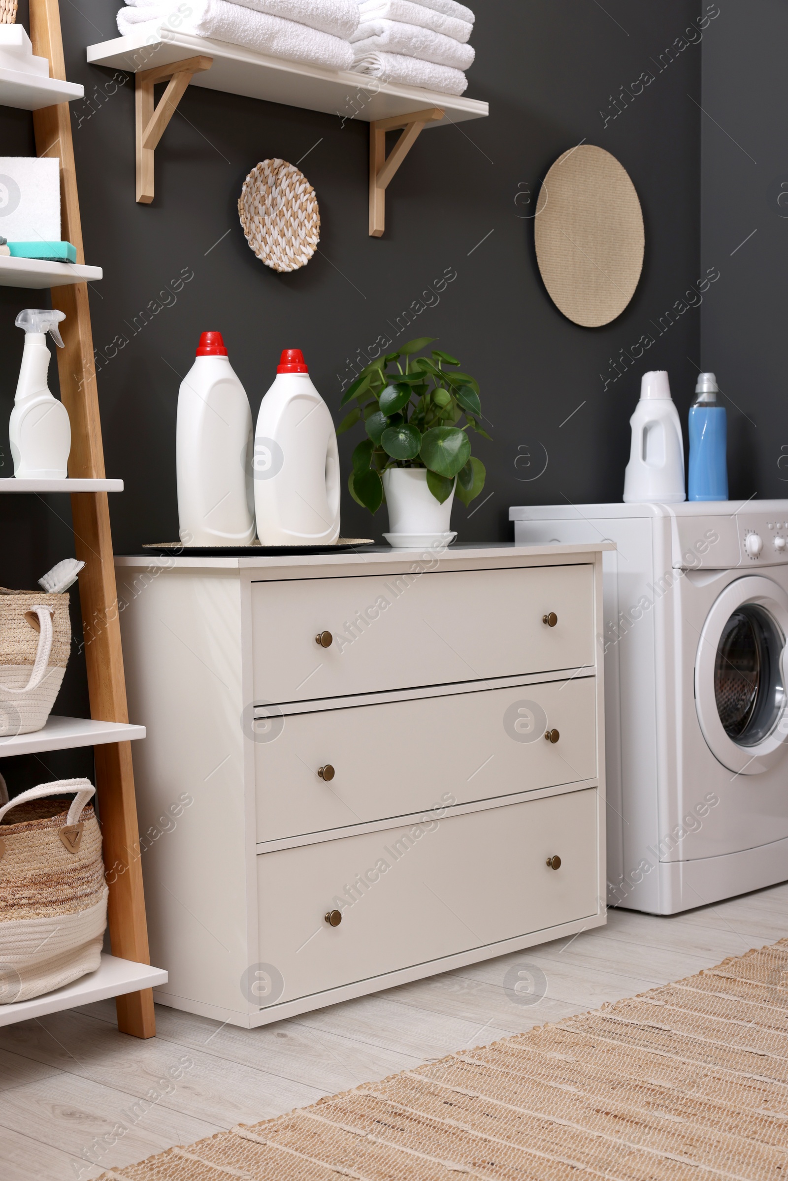 Photo of Laundry room interior with washing machine and furniture