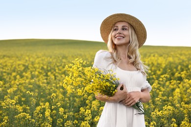 Portrait of happy young woman in field on spring day