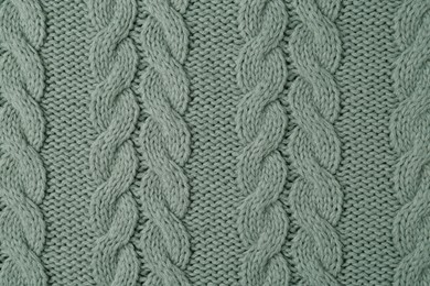 Photo of Knitted fabric with beautiful pattern as background, top view