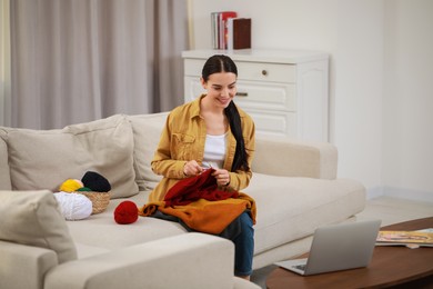 Photo of Teacher conducting online knitting course at home. Time for hobby