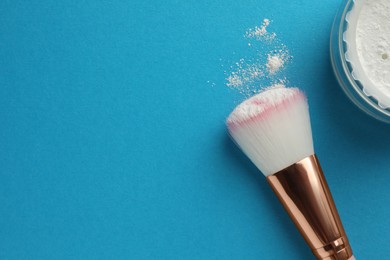 Photo of Rice loose face powder and makeup brush on light blue background, flat lay. Space for text