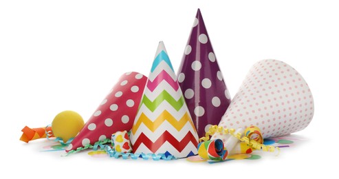 Photo of Colorful party hats, blowers and confetti streamers on white background