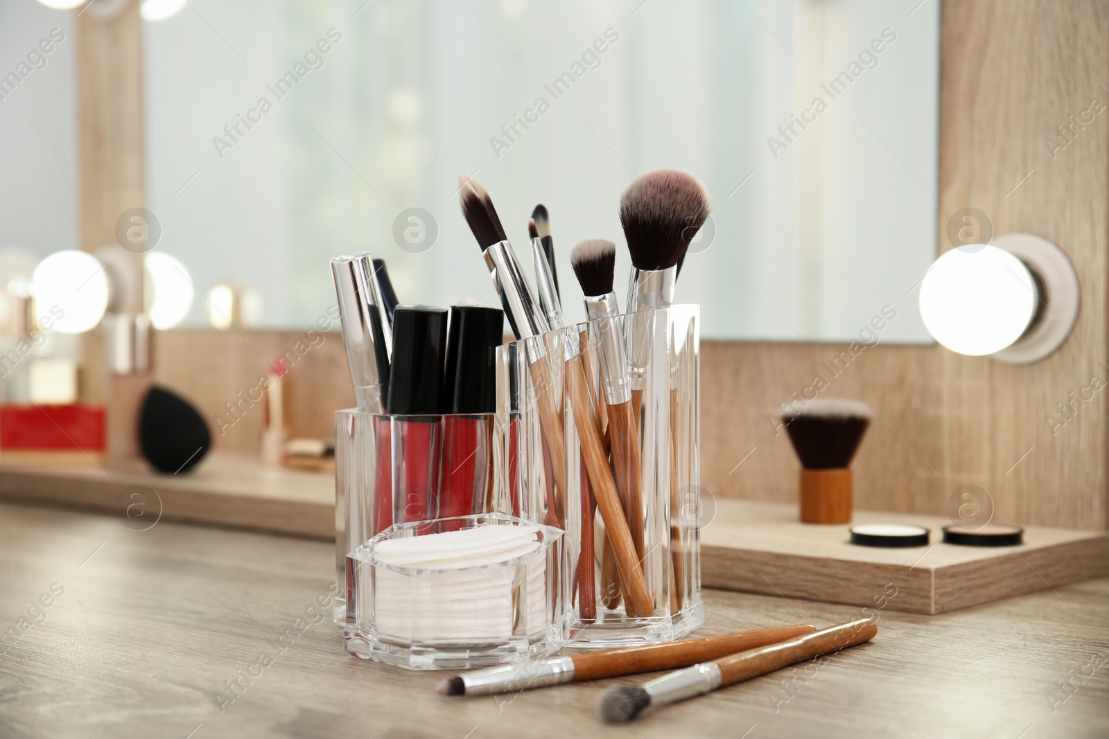 Photo of Makeup cosmetic products and tools on dressing table