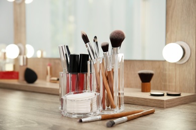 Makeup cosmetic products and tools on dressing table