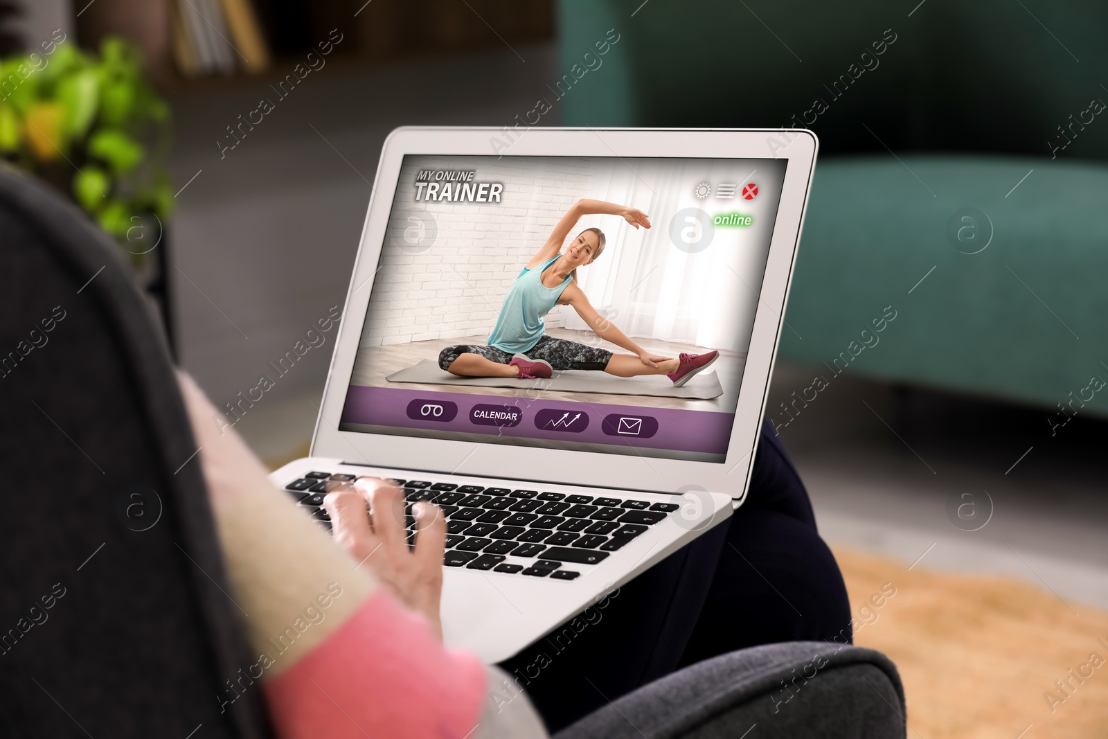 Image of Personal trainer online. Man viewing website via laptop at home, closeup