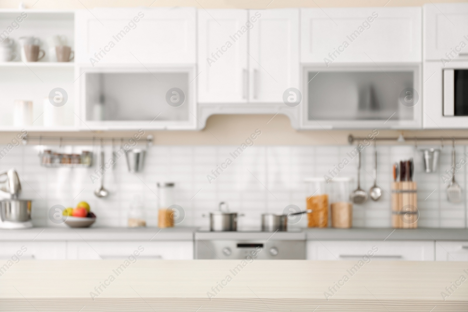 Photo of Countertop and blurred view of kitchen interior on background