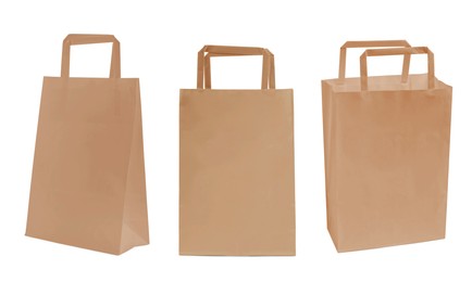 Set with kraft paper bags on white background