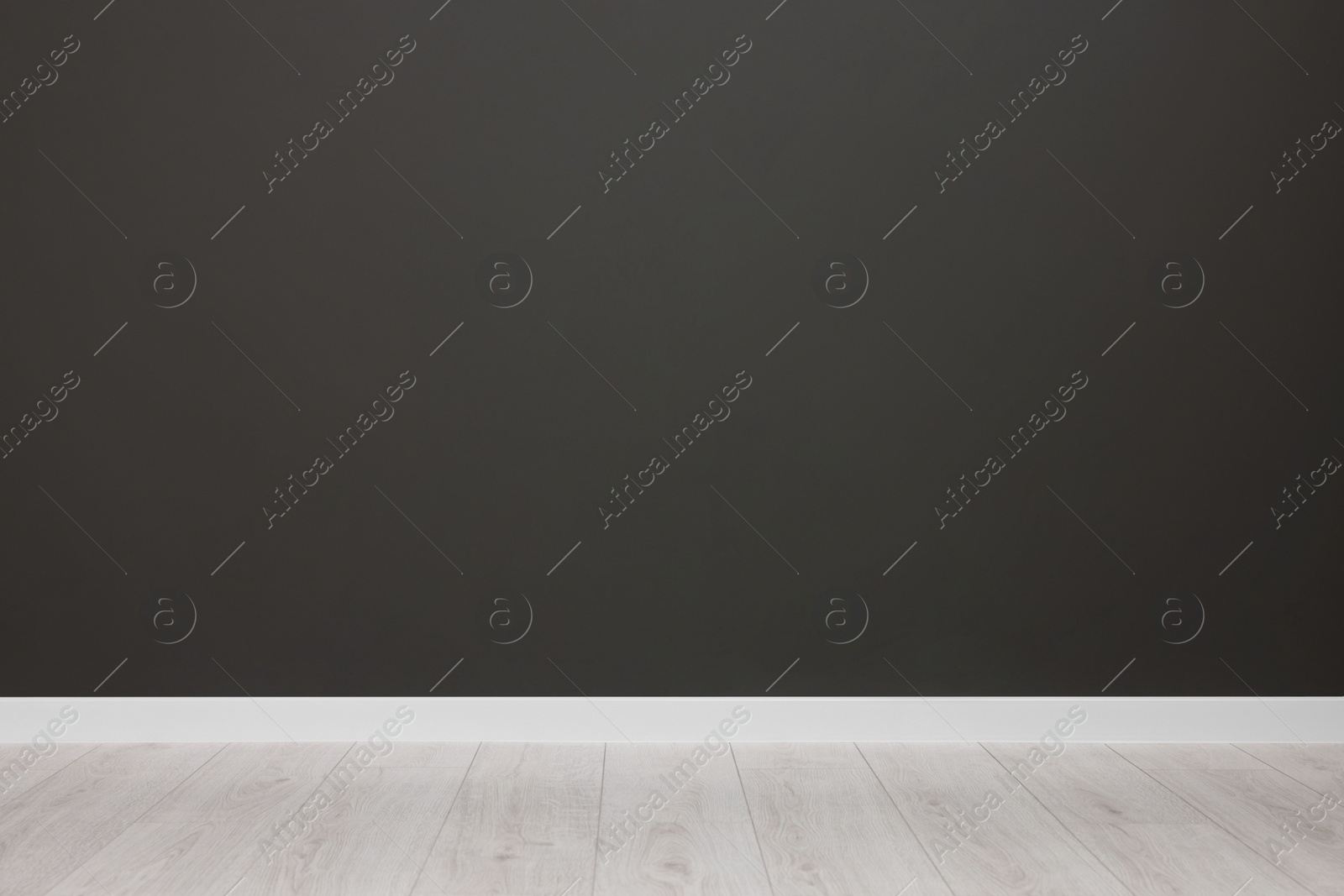 Photo of Empty room with black wall and wooden floor