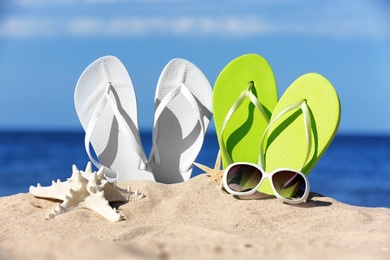 Photo of Composition with beach accessories on sand near sea in summer