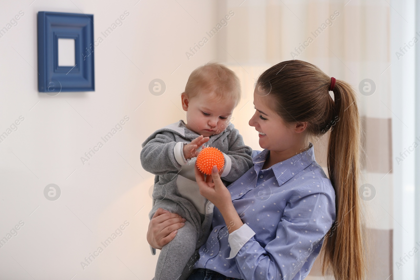 Photo of Teen nanny with cute little baby at home