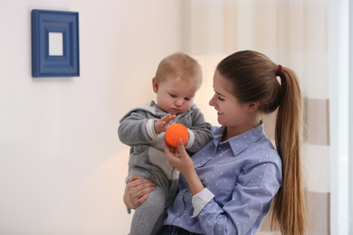 Photo of Teen nanny with cute little baby at home