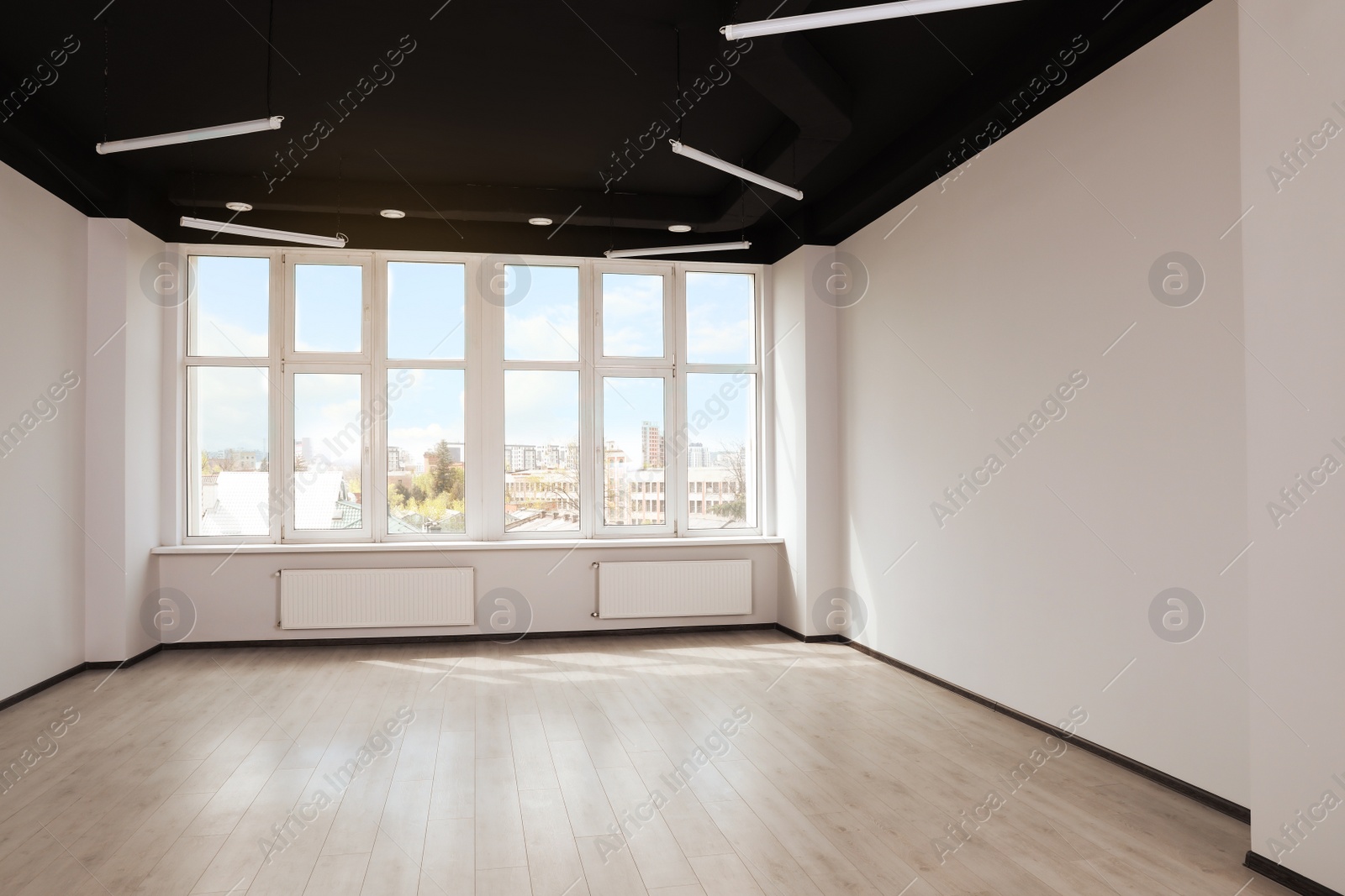 Photo of Modern office with window and radiators. Interior design