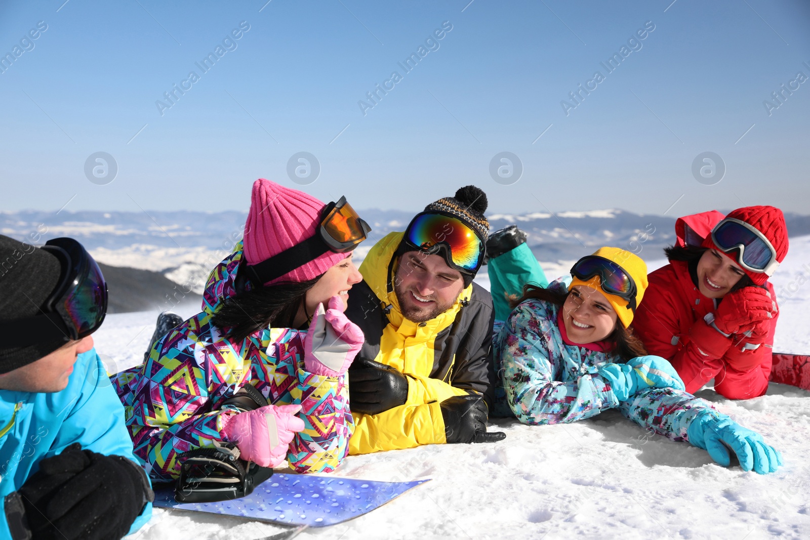 Photo of Group of friends lying on hill. Winter vacation