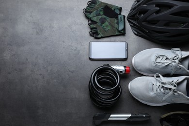 Photo of Flat lay composition with different cycling accessories on grey background, space for text