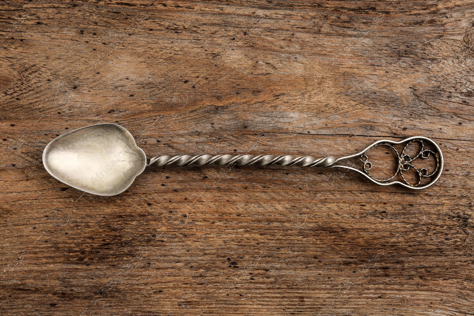 Photo of Clean vintage tea spoon on wooden background, top view