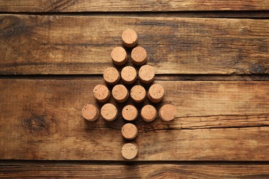 Christmas tree made of wine corks on wooden table, top view