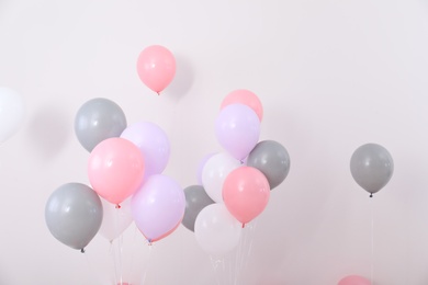 Photo of Bright balloons near color wall. Festive decoration