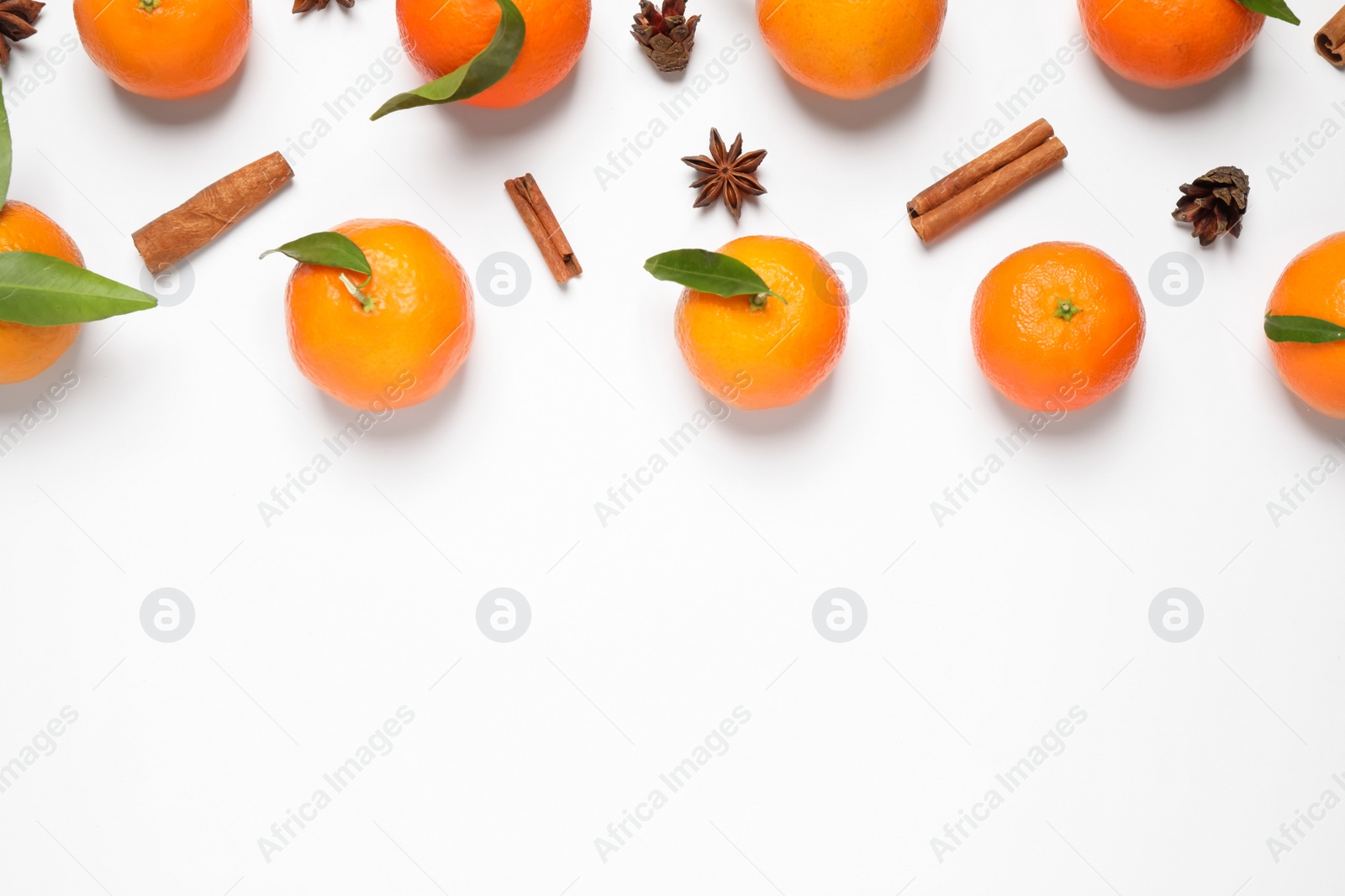 Photo of Christmas composition with tangerines on white background, flat lay. Space for text